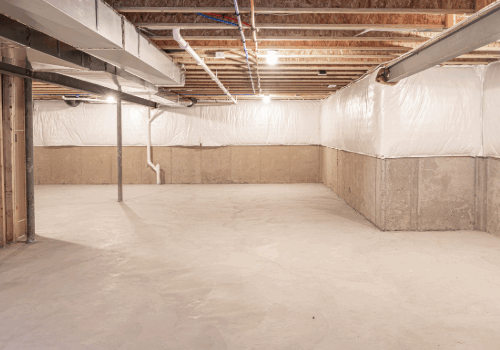 Finished basement with waterproofed walls and sealed floors, showcasing clean and protected concrete surfaces.